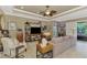 Cozy living room featuring a ceiling fan, a large TV, and comfortable seating, ideal for entertaining guests at 1088 Bluffwood Dr, Nokomis, FL 34275