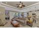 Spacious living room with a ceiling fan, ample seating, and a view to the kitchen and backyard at 1088 Bluffwood Dr, Nokomis, FL 34275