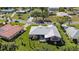 A stunning aerial view showcases the home nestled in a lush landscaped yard in a quiet neighborhood at 111 2Nd St, Nokomis, FL 34275