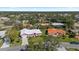 An aerial view showing the home in a lovely neighborhood with mature trees and greenery at 111 2Nd St, Nokomis, FL 34275