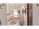 A tiled bathroom offers a tub and shower with framed decorations and plenty of light at 111 2Nd St, Nokomis, FL 34275