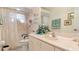 Well-lit bathroom boasts a vanity with a sink, mirror, and decorative accents at 111 2Nd St, Nokomis, FL 34275