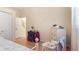 Bright bedroom with a table, chair and dresser with flowers and decor at 111 2Nd St, Nokomis, FL 34275