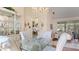 Bright dining area featuring a glass table, chandelier, and a decorative china cabinet at 111 2Nd St, Nokomis, FL 34275