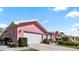 Delightful pink home with a two-car garage and a paved driveway at 111 2Nd St, Nokomis, FL 34275