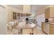 Open kitchen with island seating, light wood cabinets, and views into the adjacent living space at 111 2Nd St, Nokomis, FL 34275