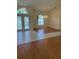 Open-concept living area with tiled entry and hardwood floors, well-lit by natural light at 111 2Nd St, Nokomis, FL 34275