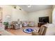 Open living room featuring cozy seating, wood flooring, and large windows for natural light at 111 2Nd St, Nokomis, FL 34275