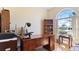 A spacious office with a large arched window lets in ample natural light at 111 2Nd St, Nokomis, FL 34275