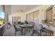 Covered patio with a glass-top table with seating, ceiling fan, and slider to the outside at 111 2Nd St, Nokomis, FL 34275