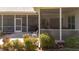 A view of the screened in patio with outdoor chairs, grill and potted plants at 111 2Nd St, Nokomis, FL 34275
