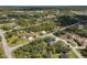 Scenic aerial view of homes nestled among mature trees, showcasing the neighborhood's peaceful, wooded setting at 1131 Chalmer Ter, Port Charlotte, FL 33953