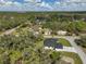 Expansive aerial view of a single-story home surrounded by lush, green trees and well-maintained landscaping at 1131 Chalmer Ter, Port Charlotte, FL 33953