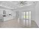 Living room featuring wood-look tile floors, an open layout, and access to the kitchen at 1131 Chalmer Ter, Port Charlotte, FL 33953