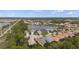 Aerial view showing the community layout with homes surrounding a peaceful pond and natural areas at 11415 Fort Lauderdale Pl, Venice, FL 34293