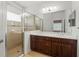 Bathroom boasts double vanity, spacious shower with glass door, and ample natural light at 11415 Fort Lauderdale Pl, Venice, FL 34293