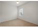 Inviting bedroom with neutral walls, tile floors, and ample natural light from a window at 11415 Fort Lauderdale Pl, Venice, FL 34293