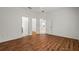 Spacious bedroom with wood floors features multiple doorways and a ceiling fan at 11415 Fort Lauderdale Pl, Venice, FL 34293