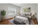 Cozy bedroom with natural light, wood floors, neutral accents, and decorative pillows at 11415 Fort Lauderdale Pl, Venice, FL 34293