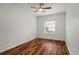 Cozy bedroom features wood floors, a ceiling fan, and a window offering natural light at 11415 Fort Lauderdale Pl, Venice, FL 34293