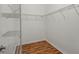 Walk-in closet with metal racks and wood flooring at 11415 Fort Lauderdale Pl, Venice, FL 34293