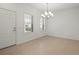 Dining room with tile floors, a chandelier, a door, and two windows at 11415 Fort Lauderdale Pl, Venice, FL 34293