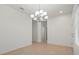 Dining room with tile floors, a chandelier, and a view into the hallway at 11415 Fort Lauderdale Pl, Venice, FL 34293