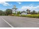 Welcoming Grand Palm entrance with beautiful landscaping, blue accents, and clear blue skies at 11415 Fort Lauderdale Pl, Venice, FL 34293