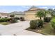 Charming one-story yellow home with a well-maintained lawn and a two-car garage at 11415 Fort Lauderdale Pl, Venice, FL 34293
