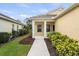 Inviting yellow home with a charming front porch and meticulously landscaped yard at 11415 Fort Lauderdale Pl, Venice, FL 34293