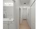 Hallway with bathroom, linen closet, light fixture and tile flooring at 11415 Fort Lauderdale Pl, Venice, FL 34293