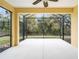 Spacious screened lanai overlooking a private backyard with lush greenery at 11415 Fort Lauderdale Pl, Venice, FL 34293
