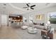 Bright, open-concept living room showcasing modern decor, lots of natural light, and seamless flow to the kitchen at 11415 Fort Lauderdale Pl, Venice, FL 34293