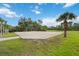 Sand volleyball court surrounded by lush landscaping at 11415 Fort Lauderdale Pl, Venice, FL 34293