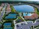 Aerial view showcasing the community amenities, including tennis courts, a pool, and a playground at 11558 Renaissance Blvd, Venice, FL 34293