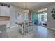 Bright dining area with a dining table and chairs next to a sliding door to an outdoor porch at 11558 Renaissance Blvd, Venice, FL 34293