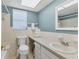 Well-lit bathroom featuring a modern sink, vanity, and a large mirror at 1220 Lakeside Dr, Venice, FL 34293