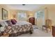 Inviting bedroom with natural light, a floral-patterned bed, and a cozy ambiance at 1220 Lakeside Dr, Venice, FL 34293
