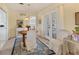 Cozy dining area featuring a round table, white chairs, and natural light from the French doors at 1220 Lakeside Dr, Venice, FL 34293