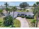 Single story home with mature landscaping, driveway, well maintained lawn and neutral color scheme at 1220 Lakeside Dr, Venice, FL 34293