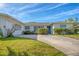 Single story home with mature landscaping, driveway, well maintained lawn and neutral color scheme at 1220 Lakeside Dr, Venice, FL 34293