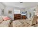 Cozy living room with a piano, TV, and comfortable seating, bathed in soft natural light at 1220 Lakeside Dr, Venice, FL 34293