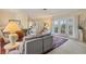 A spacious living room with gray sofa and glass doors leading to the outdoors at 1220 Lakeside Dr, Venice, FL 34293