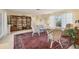 Bright living room with a large Persian rug, open shelving and plenty of seating options at 1220 Lakeside Dr, Venice, FL 34293