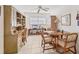 Bright living room with a ceiling fan, desk, dining table, tile flooring and wooden furniture at 1220 Lakeside Dr, Venice, FL 34293