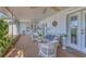 Relaxing screened porch with comfortable seating, ceiling fans, and a view of the outdoors at 1220 Lakeside Dr, Venice, FL 34293