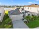 Aerial view of home overlooking a lake with a fountain and beautiful green landscaping at 12637 Promenade Estates Blvd, Sarasota, FL 34238