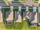 Aerial view of neighborhood houses with well maintained green lawns in sunny summer conditions at 12637 Promenade Estates Blvd, Sarasota, FL 34238