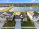 Aerial view of home featuring a lake view with fountain and well-maintained landscaping at 12637 Promenade Estates Blvd, Sarasota, FL 34238