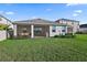 The backyard offers a lush lawn and a covered patio at 12637 Promenade Estates Blvd, Sarasota, FL 34238